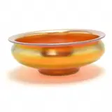 Carder Aurene Glass Centerpiece Bowl. by Alexander Joseph von Steuben, 1915, Blown and moulded glass. Flat, everted rim over waisted neck, issuing the squat bowl. Polished inverted pontil to unders, sold Sep 2019