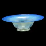 Blue Pastel Iridescent Glass Bowl. by Tiffany Studios, 1920, Blown and moulded glass with broad rim, tapering bowl, and slight foot. Blue-purple iridescent rim, and white ribbons. P, sold Sep 2019