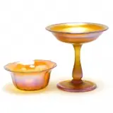 Gold Favrile Glass Candy Bowl. by Tiffany Studios, 1900, Swirled, blown-moulded candy bowl, with polished pontil and an American gold favrile glass compote, with ground pontil, sold Sep 2019