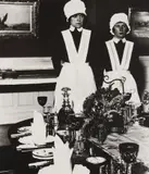 Parlourmaid and under-parlourmaid ready to serve dinner by Bill Brandt, 1936, Gelatin silver print, printed later, sold Oct 2018
