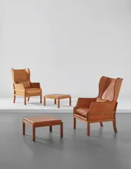 Mogens Koch, Pair of wingback armchairs and ottomans, 1970s, Honduran mahogany, leather
