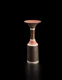 Bottle with cylindrical body and flaring lip by Lucie Rie, circa 1968, Porcelain, golden manganese glaze, dry terracotta shoulder and lip, with radiating sgraffito design, three bands of blue, sold Jun 2018