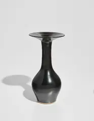 Bottle with flaring lip by Lucie Rie, circa 1962, Stoneware, mirror-black glaze, sold Jun 2018