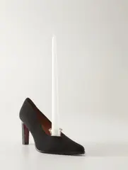 Foot Candle by Carl Andre, 2002, leather and black cloth shoe, pressed glass candlestick holder and candle, offered Nov 2017