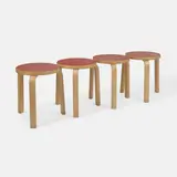 Alvar Aalto, Set of four '60' stools, 1933, each of birch plywood with a red laminate top (4)