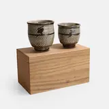 Shimaoka Tatsuzo, Pair of tea bowls, each covered in braided grey glaze with iron decoration