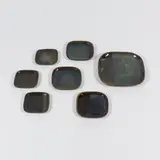 Pierre Culot, Suite de six assiettes et un grand plat, A set of six plates and one serving dish in partially glazed stoneware by Pierre Culot circa 1988 and circa 1985 with the artist's seals
