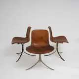 Poul Kjaerholm, Suite de trois chaises PK9, A set of three impressed 'PK9' chairs in steel, fiberglass and leather designed by Poul Kjaerholm in 1960 and edited by E
