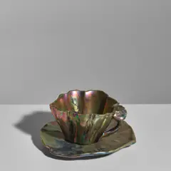Cup and Saucer by Clement Massier, lustre-glazed stoneware, the cup inscribed 'Golfe JUAN A, sold Oct 2025