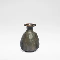 Janet Leach, Cut bottle vase, circa 1989, Stoneware, dry brown body with cut sides and shiny tenmoku glaze to flared rim