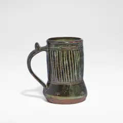 Ladi Kwali, Tankard, Glazed stoneware, tenmoku glaze with streaked iron decoration, the curved handle with a thumbpiece