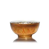 Daisy Makeig-Jones, for Wedgwood, circa 1925, Glazed porcelain, decorated in orange and gilt with masks and geometric patterns against a gilt lustre ground