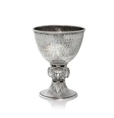 Chalice by Omar Ramsden, 1924, Silver, the hammered bowl raised on a twisted knop with lion masks in relief, on a splayed foot, sold Dec 2024