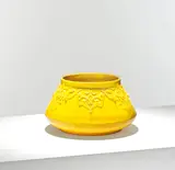 Christopher Dresser, for William Ault & Co., circa 1895, Glazed earthenware, of wide tapering form, the exterior decorated in yellow with stylised foliate motifs in relief