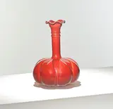 Christopher Dresser, for William Ault & Co., circa 1895, Glazed earthenware, the bulbous body rising to a narrow neck and a pinched rim, decorated in red with incised motifs