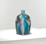 Christopher Dresser, for William Ault & Co., circa 1895, Glazed stoneware, of ovoid form with indented sides, decorated in a blue, purple, and black streaked glaze