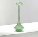 for James Couper & Sons by Christopher Dresser, circa 1895, Green glass, the conical body tapering to a slender neck surmounted with a pinched and folded rim, sold Mar 2025