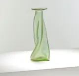for Loetz by Christopher Dresser, circa 1896, Matte green and clear glass, the twisted tapering body rising to a triangular rim with pinched edges, sold Mar 2025