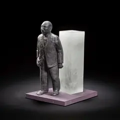 David Reekie, Walking Away, 1989, Cast black and pate de verre glass, modelled as a walking man in front an opaque glass monolith, on a painted wooden base