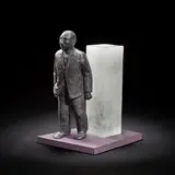David Reekie, Walking Away, 1989, Cast black and pate de verre glass, modelled as a walking man in front an opaque glass monolith, on a painted wooden base