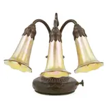 THREE-LIGHT ‘LILY’ PIANO LAMP, CIRCA 1910 by Tiffany Studios, 1910, patinated bronze and favrile glass, sold Nov 2020