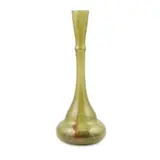 'CLUTHA' GLASS VASE, CIRCA 1880 by Christopher Dresser, 1880, the green glass with opaque swirls and aventurine inclusions, sold Apr 2020