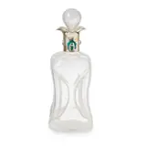 Archibald Knox, ARTS & CRAFTS SILVER-MOUNTED DECANTER, BIRMINGHAM 1906, 1906, the silver mount set with two turquoise cabochons and two stylised circular enamel roundels