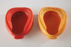 John Baldessari, Repository (Orange/Blue); and Repository (Red/Green), 2002, Two white ceramic multiples with sprayed glaze surface and screened glaze text