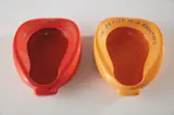 John Baldessari, Repository (Orange/Blue); and Repository (Red/Green), 2002, Two white ceramic multiples with sprayed glaze surface and screened glaze text