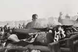 Gandhi's secretary watches the first flames of the funeral pyre, Delhi, India by Henri Cartier-Bresson, 1948, Gelatin silver print, printed later, sold Dec 2017