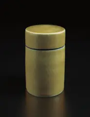 Lidded jar by Lucie Rie, circa 1960, Stoneware, yellow glaze, the interior of the lip and the underside matte blue with diagonal sgraffito lines, sold Jun 2017