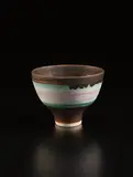 Footed bowl by Lucie Rie, circa 1978, Porcelain, pink, turquoise, and golden manganese bands, sold Dec 2017