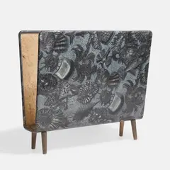 Magazine rack by Piero Fornasetti, the interior in cream with a brass central division, sold Apr 2026