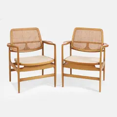 Sergio Rodrigues, Pair of 'Oscar' chairs, 1956, each with an oak frame with rounded arms and a cane back
