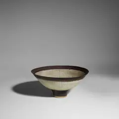 Lucie Rie, Footed Bowl, glazed stoneware, radiating lines of sgraffito, manganese-glazed foot and lip, impressed artist's seal 'LR'