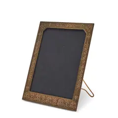 PICTURE FRAME by Tiffany Studios, New York, New York, early 20th century, gilt bronze, integrated stand, impressed stamp mark "Tiffany Studios New York 18, sold May 2025