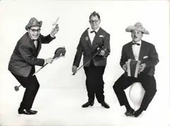 Heinz Simonis, The cabaret and music trio 'Die 3 Spitzbuben', Vienna c. 1970, 1970, Vintage silver print on double-weight matte paper, flush-mounted on heavy cardboard, in good condition. "Die 3 Spitzbuben" (The 3 Rascals) started as a popular cabaret trio in Viennese wine taverns, m
