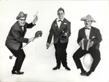 Heinz Simonis, The cabaret and music trio 'Die 3 Spitzbuben', Vienna c. 1970, 1970, Vintage silver print on double-weight matte paper, flush-mounted on heavy cardboard, in good condition. "Die 3 Spitzbuben" (The 3 Rascals) started as a popular cabaret trio in Viennese wine taverns, m
