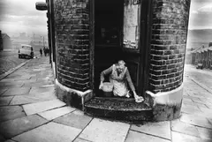 Collin Jones, Shopkeeper washing her doorstep, Benwell, Newcastle-upon-Tyne, England 1963, 1963, Gelatin silver print, printed later on double-weight semi-matte paper