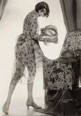 Atelier Manasse, Ruth Gold in dressing gown selecting a hat, 1928, Vintage silver print on double-weight semi-matte paper, in very good condition. Photographer's studio stamp "Foto-Salon Manassé, Wien, 1., Getreidemarkt 16", agency stamp "Wiener Foto-Kurier" and anno
