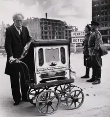 Robert Capa, Organ grinder in the Russian zone, Berlin 1945, 1945, Gelatin silver print, printed in the 1960s on double-weight semi-matte paper