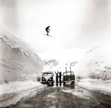 Hans Truöl, Skier jumping over the alpin road at Arlberg, Austria 1959, 1959, Gelatin silver print, printed in the late 1970s on single-weight glossy Agfa paper