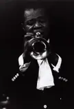 Dennis Stock, Louis Armstrong, from the series 'Jazz Street', USA 1958, 1958, Gelatin silver print, printed in the 1970s on double-weight semi-matte paper, in very good condition. Photographer's Magnum copyright stamp, handwritten negative no. "58-4-166/26" in blue ink and "Lou