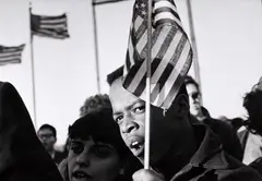 Hiroji Kubota, Protesters with US flags, Washington DC 1965, 1965, Vintage silver print on double-weight semi-matte paper, in excellent condition. Signed in black ink, Magnum distribution stamp, date stamp "1965", handwritten negative no. "65-3-1/28" and credited "H.