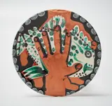 Pablo Picasso, Mains au poisson (Hands with Fish), 1953, Red earthenware round dish painted in colors, with engraving and partial brushed glazed