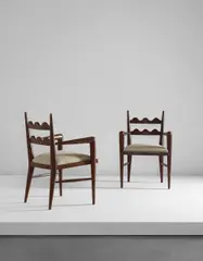 Jean Royere, Pair of “Ondulation” armchairs, circa 1950, Oak, fabric