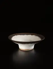 Large bowl by Lucie Rie, circa 1970, Stoneware, matte white glaze with golden manganese lip, sold Jun 2016