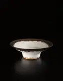 Large bowl by Lucie Rie, circa 1970, Stoneware, matte white glaze with golden manganese lip, sold Jun 2016