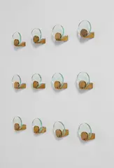 Set of twelve wall-mounted coat hangers by Fontana Arte, circa 1960, Glass, brass, sold Jun 2016