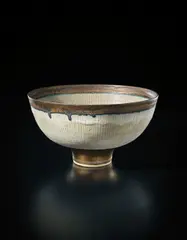Footed bowl by Lucie Rie, circa 1978, Stoneware, inlaid green lines, golden manganese bands, sold Dec 2016